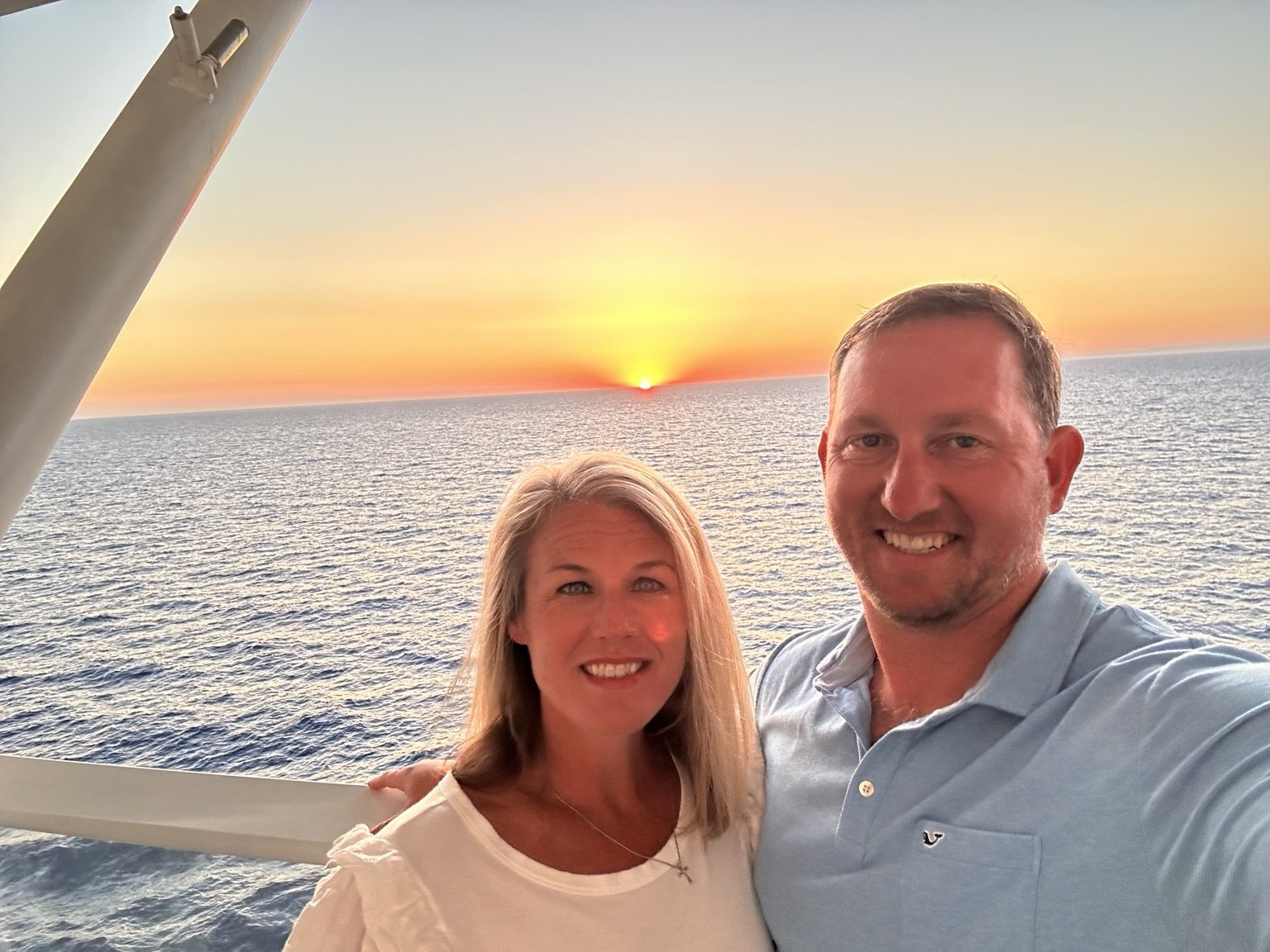 John Messer with his wife at sunset overlooking the water